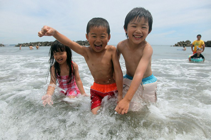 Children swim in the sea at the Nakoso beach in Iwaki city in Fukushima prefecture, 65km south of the crippled TEPCO nuclear power plant, on July 16, 2013
